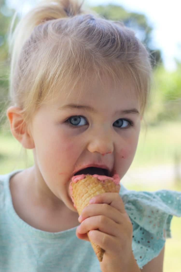 Sadie easting a strawberry ice cream cone