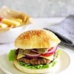Homemade beef burger with fries in the background