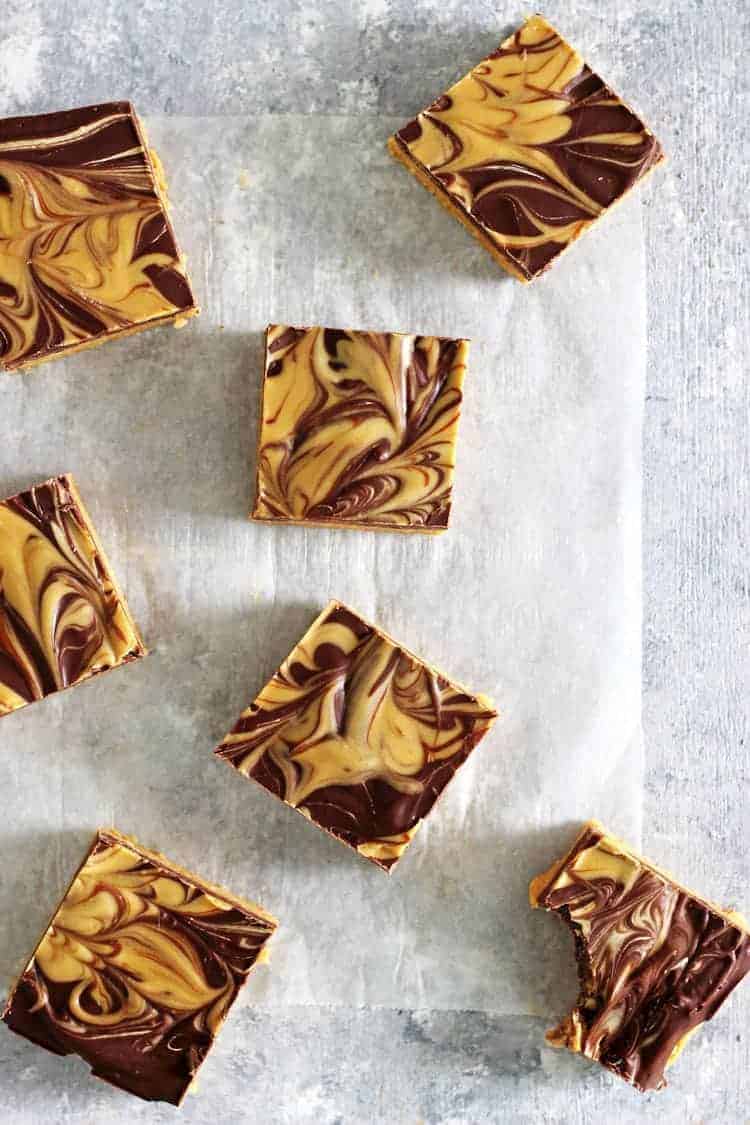 Overhead shot of no bake chocolate peanut butter bars on a white background