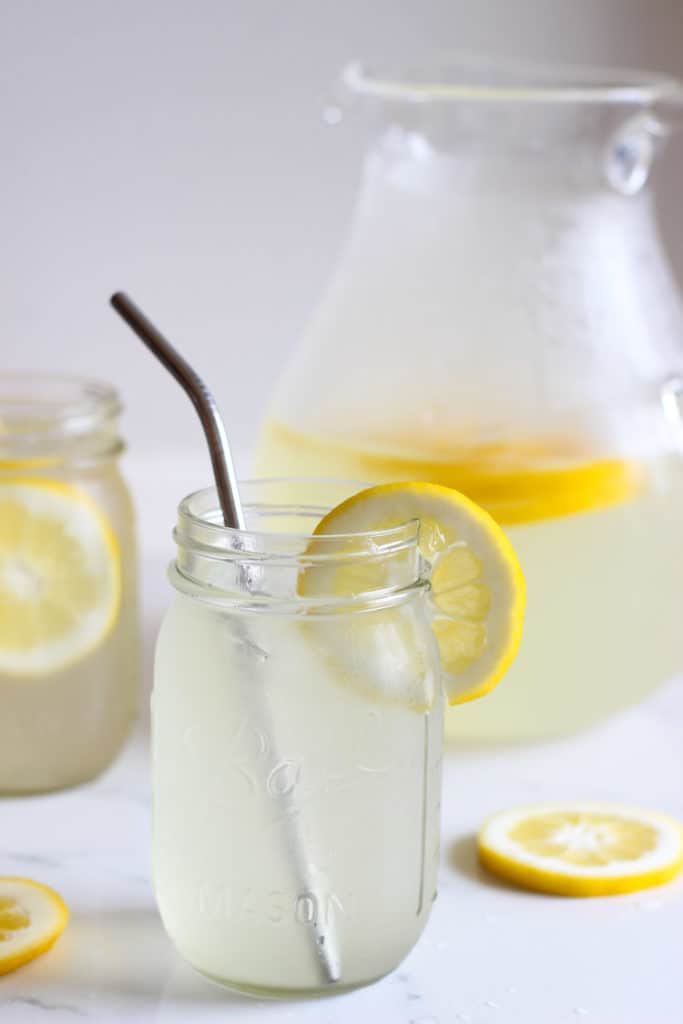 Pitcher of homemade lemonade on a white background