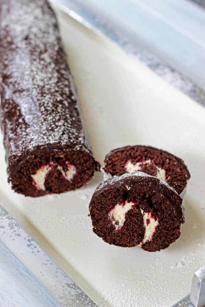 A soft chocolate sponge cake roll, filled with whipped cream and jam, and covered in chocolate icing!