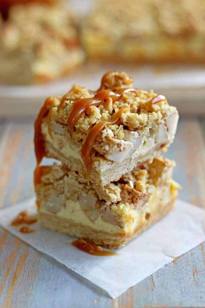 Buttery, spiced Apple Crumble Cheesecake Bars - the perfect autumn dessert and made even better drizzled with salted caramel sauce!