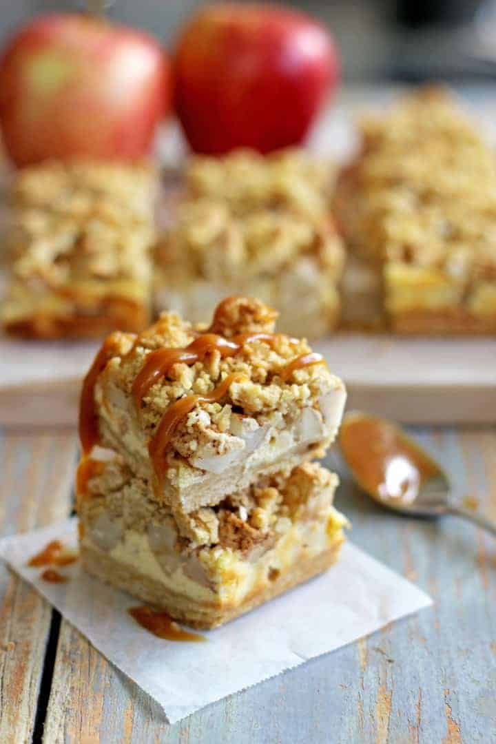 Buttery, spiced Apple Crumble Cheesecake Bars - the perfect autumn dessert and made even better drizzled with salted caramel sauce!