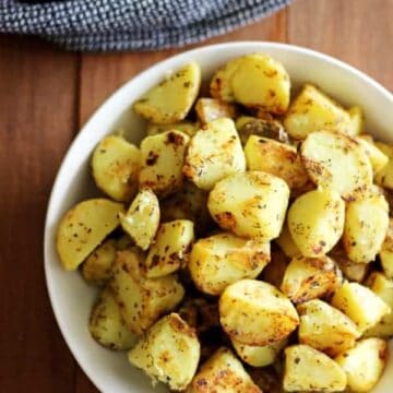 Garlic, herb & parmesan fried potatoes are the perfect side dish. They'll be your new "go-to" for potluck dinners, summer BBQ's and winter roasts! | thekiwicountrygirl.com