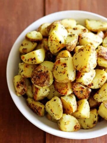 Garlic, herb & parmesan fried potatoes are the perfect side dish. They'll be your new "go-to" for potluck dinners, summer BBQ's and winter roasts! | thekiwicountrygirl.com