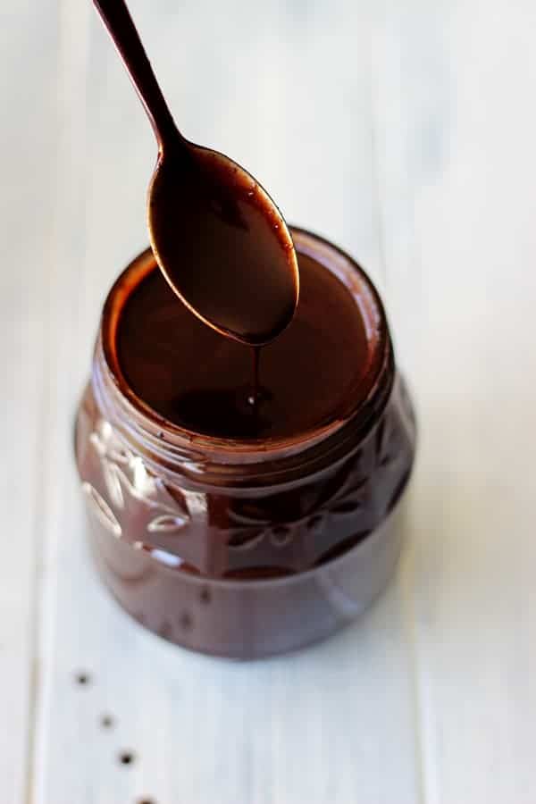 Homemade hot fudge sauce - the perfect thing to feed your ice-cream addiction, even in the middle of winter! Made from ingredients you have in your pantry! | thekiwicountrygirl.com