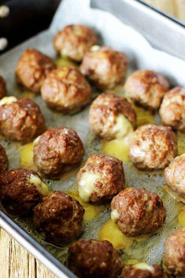 Mozzarella stuffed meatballs - the perfect quick dinner or make them mini, stick them on toothpicks and serve as an appetizer with BBQ or marinara sauce! | thekiwicountrygirl.com