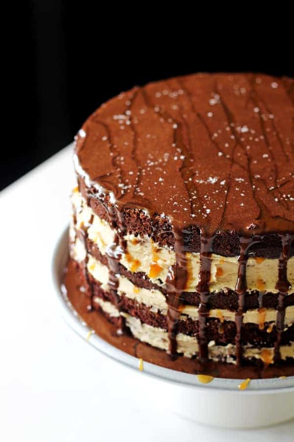My favourite chocolate cake recipe teams up with salted caramel sauce and dark chocolate ganache to make the perfect salted caramel chocolate layer cake! | thekiwicountrygirl.com