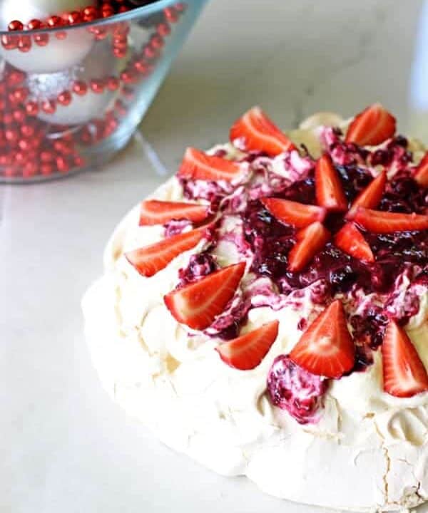 A Kiwi Christmas classic - this easy homemade pavlova will make you never want to buy one again! Covered in fresh summer berries it's the perfect dessert | thekiwicountrygirl.com
