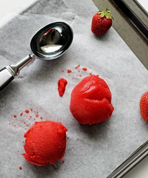 Quick and easy homemade strawberry sorbet made with only 3 ingredients - fresh strawberries, sugar syrup and lemon juice. It's the perfect summertime treat! | thekiwicountrygirl.com