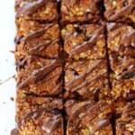 This loaded Anzac slice recipe is a twist on the traditional Anzac biscuits, filled with cranberries, apricot, walnuts and topped with a chocolate drizzle!