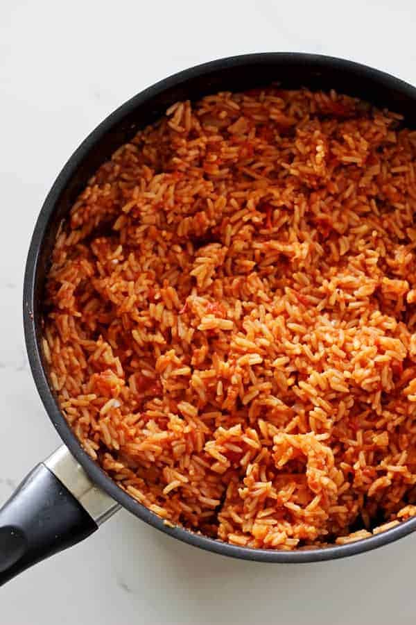 Mexican rice - the perfect quick & easy side dish to accompany any Mexican fiesta! Rice, onion, a few spices, tomatoes & fresh coriander. Delicious! | thekiwicountrygirl.com