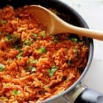 Mexican rice - the perfect quick & easy side dish to accompany any Mexican fiesta! Rice, onion, a few spices, tomatoes & fresh coriander. Delicious! | thekiwicountrygirl.com
