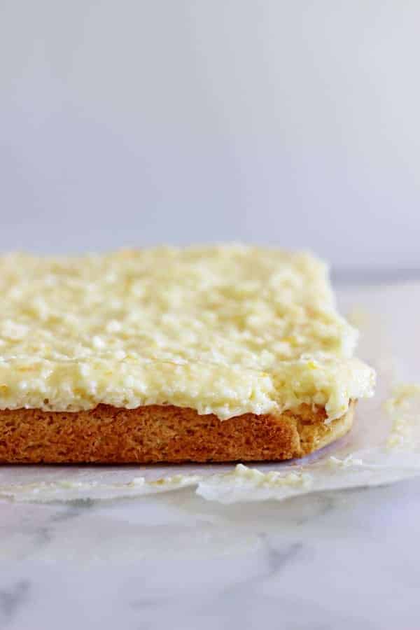 Lemon Coconut Slice - the perfect spring treat! A simple baked base topped with lemony coconut icing - keep it in the fridge for maximum deliciousness! | thekiwicountrygirl.com