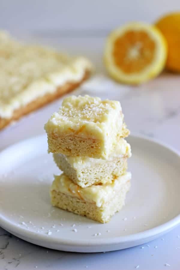 Lemon Coconut Slice - the perfect spring treat! A simple baked base topped with lemony coconut icing - keep it in the fridge for maximum deliciousness! | thekiwicountrygirl.com
