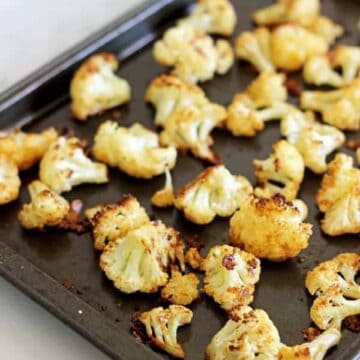 Parmesan Roasted Cauliflower - the perfect way to eat this delicious vegetable, cheesy, crispy and a great snack or side dish! | thekiwicountrygirl.com