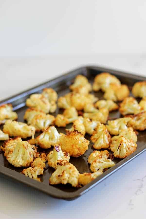 Parmesan Roasted Cauliflower - the perfect way to eat this delicious vegetable, cheesy, crispy and a great snack or side dish! | thekiwicountrygirl.com