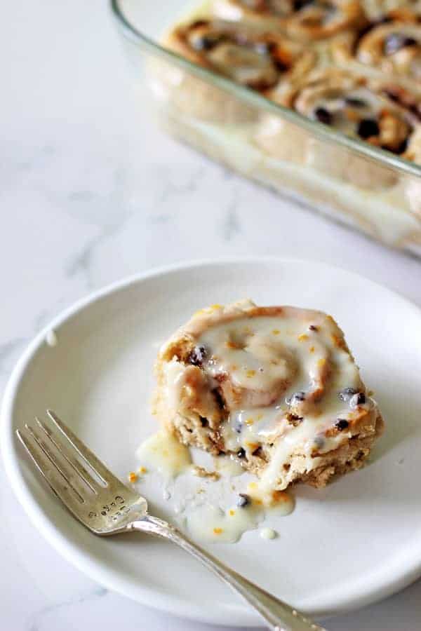 Hot Cross Bun Cinnamon Rolls! The perfect combination of delicious cinnamon rolls with all the spices and dried fruit that you love about hot cross buns! A must have for Easter brunch | thekiwicountrygirl.com