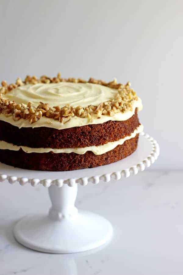 My all time favourite Carrot Cake recipe - loaded with grated carrot, crushed pineapple and crunchy walnuts and smothered in cream cheese frosting, this will become your favourite carrot cake recipe too! | thekiwicountrygirl.com