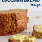 Three slices of zucchini bread in a stack on a white background with a buttered piece of zucchini bread in front with text overlay