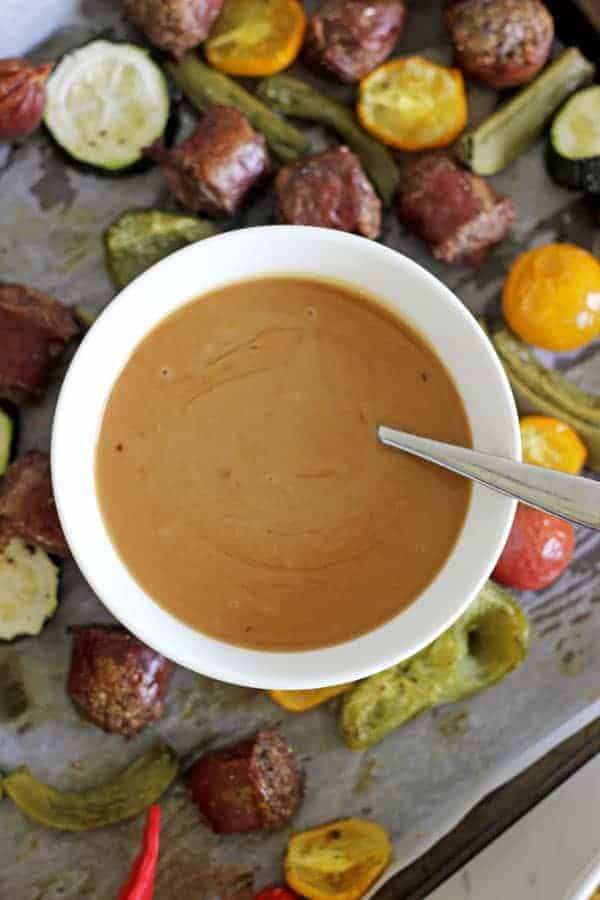 Sheet Pan Sausage & Veggies with Satay Sauce - a quick, easy and super tasty sheet pan dinner with colourful veggies, tasty sausages and a killer satay sauce! Great for weeknights and meal prep | thekiwicountrygirl.com