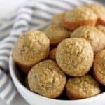 Bowl of mini banana oatmeal muffins with blue striped tea towel