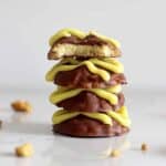 Stack of homemade hokey pokey squiggles biscuits on a white marble background