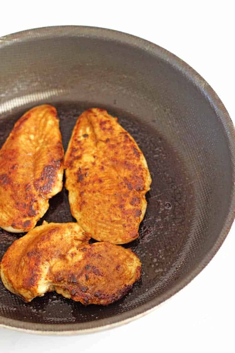 Chicken breasts cooking in a pan