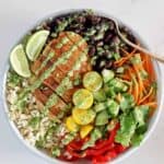Chicken burrito bowl with a fork on a white background