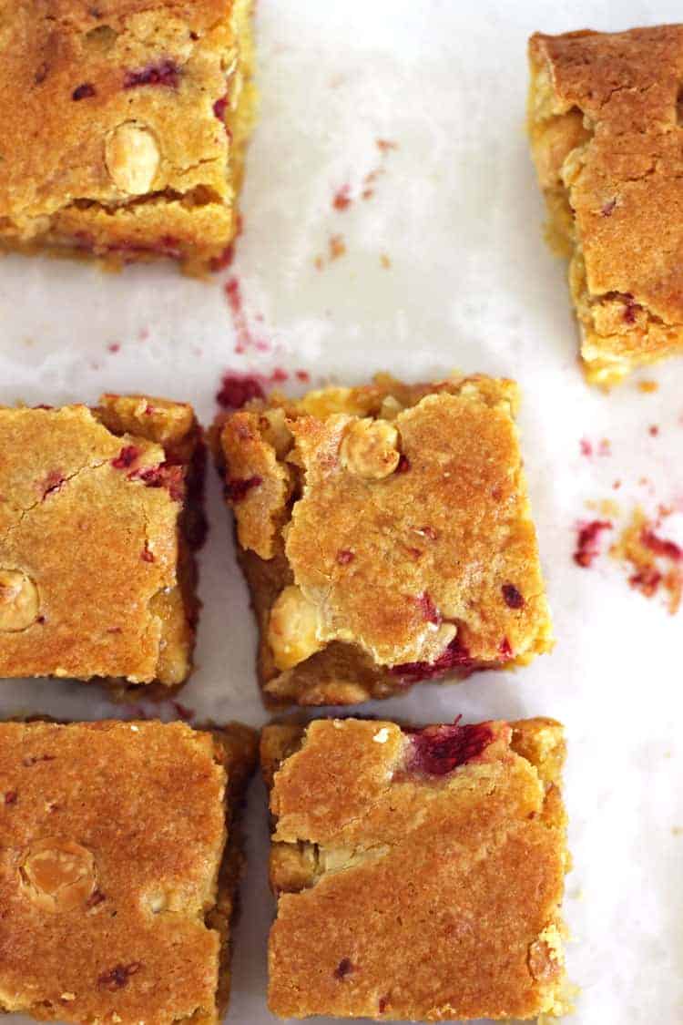 White chocolate and raspberry blondie squares on a white background