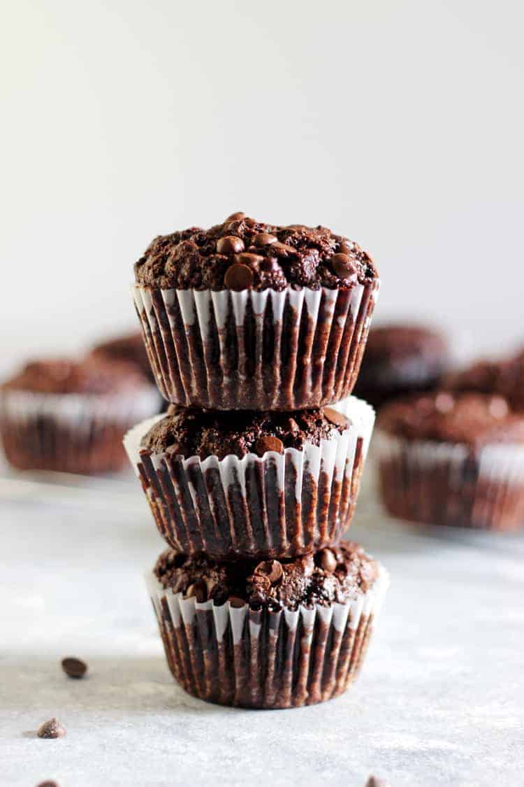 Stack of 3 double chocolate muffins with more muffins in the background