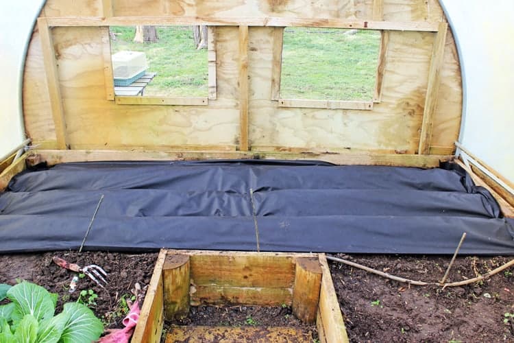 Raised garden bed with weed mat covering