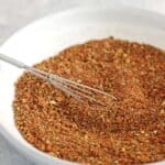 Bowl of bbq spice rub on grey background