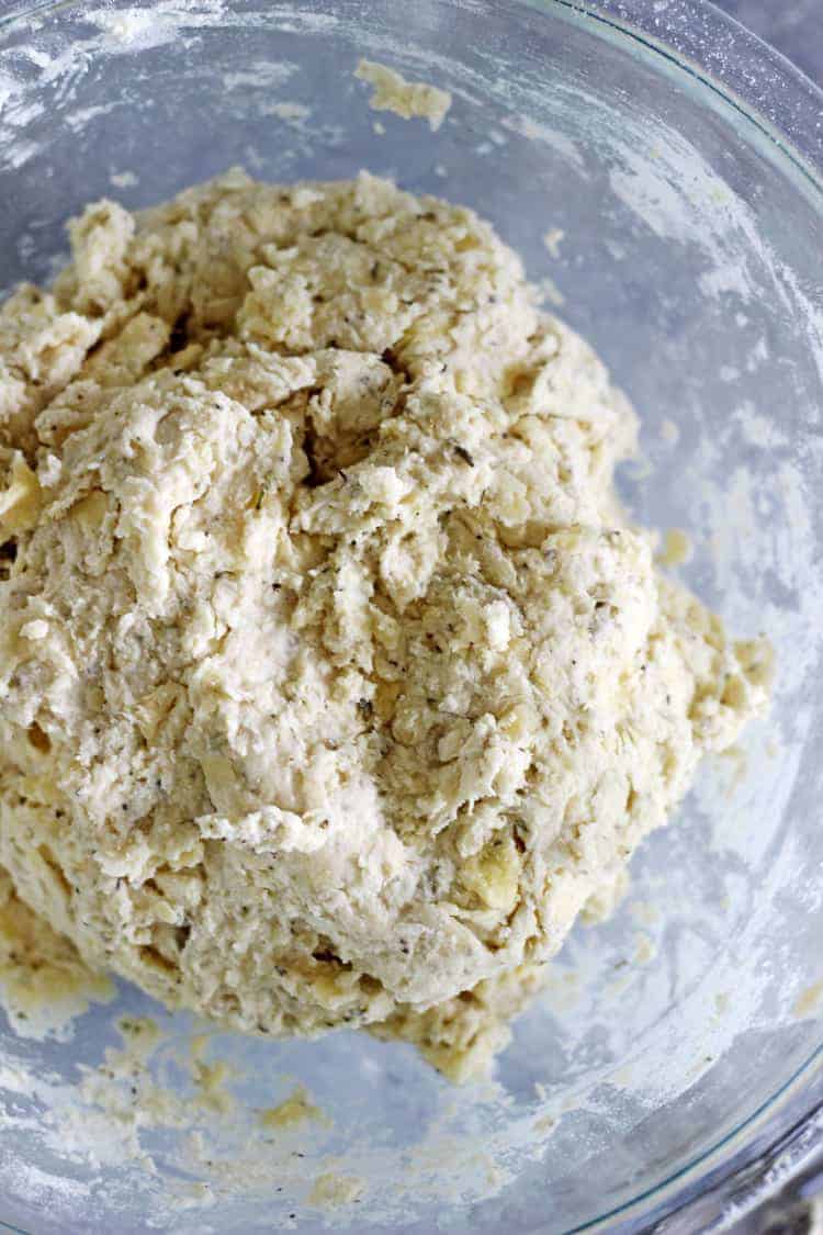 Dough for cheese scones in a glass bowl