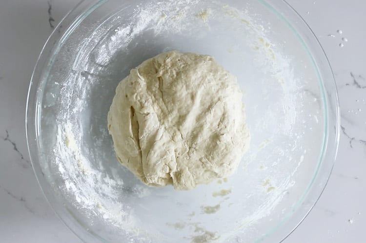 Unrisen bread dough in glass bowl
