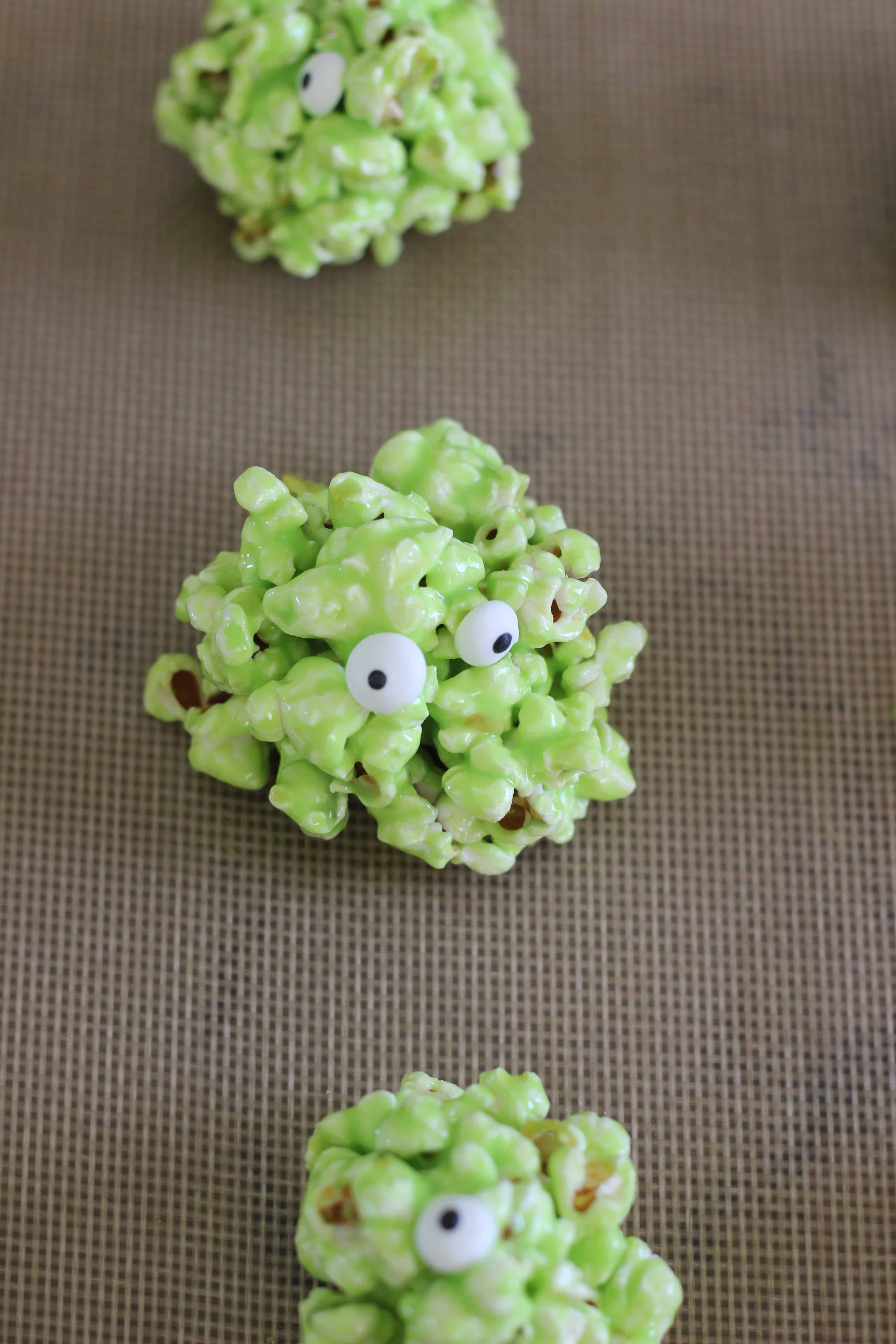 Green popcorn marshmallow slime ball with candy eyeballs