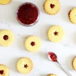 Overhead of homemade shrewsbury biscuits with homemade strawberry jam in a bowl