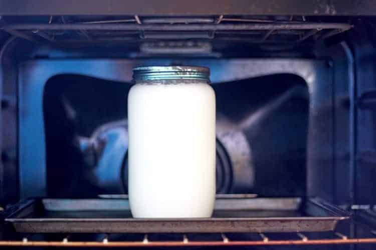 Jar of yoghurt in the oven being made