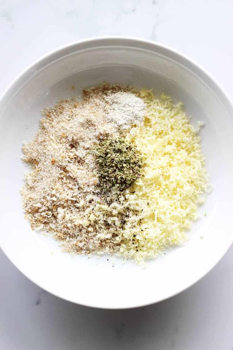 White bowl with breadcrumbs, parmesan and herbs