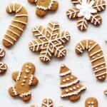 Decorated gingerbread cookies with royal icing in various shapes on a white background