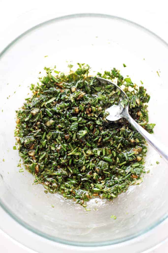 Bowl of herb marinade with spoon