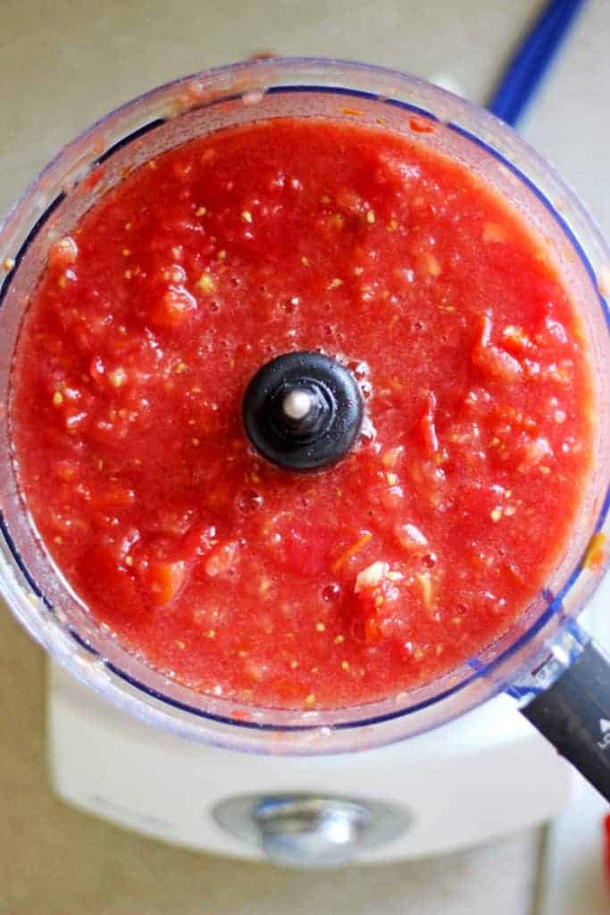 Food processor with chopped tomatoes and onions