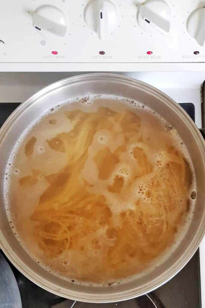 Spaghetti being cooked on the stove