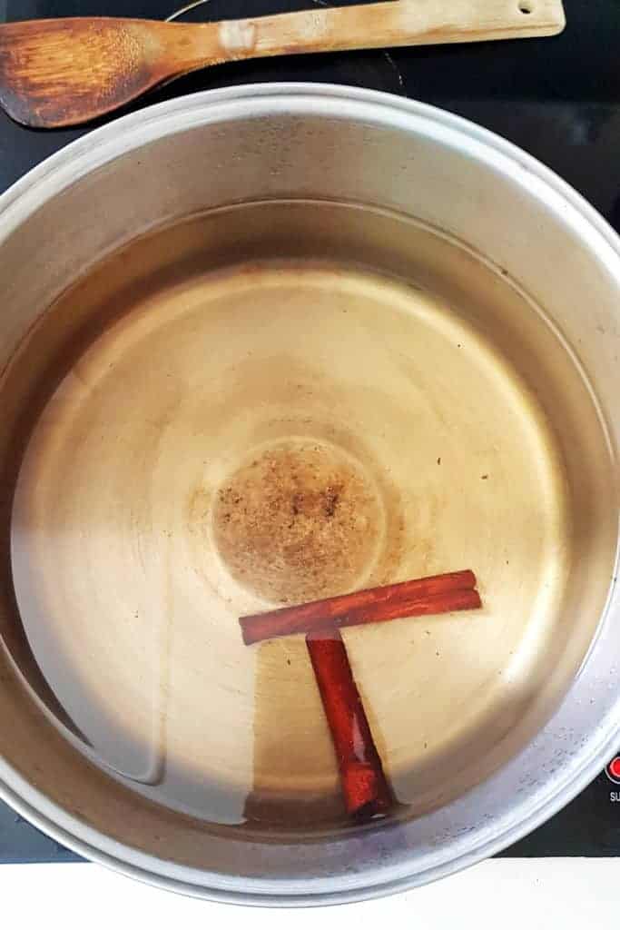 Overhead of pot with sugar syrup and cinnamon sticks