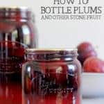 Sealed jars of bottled plums with bowl of plums in background with text overlay