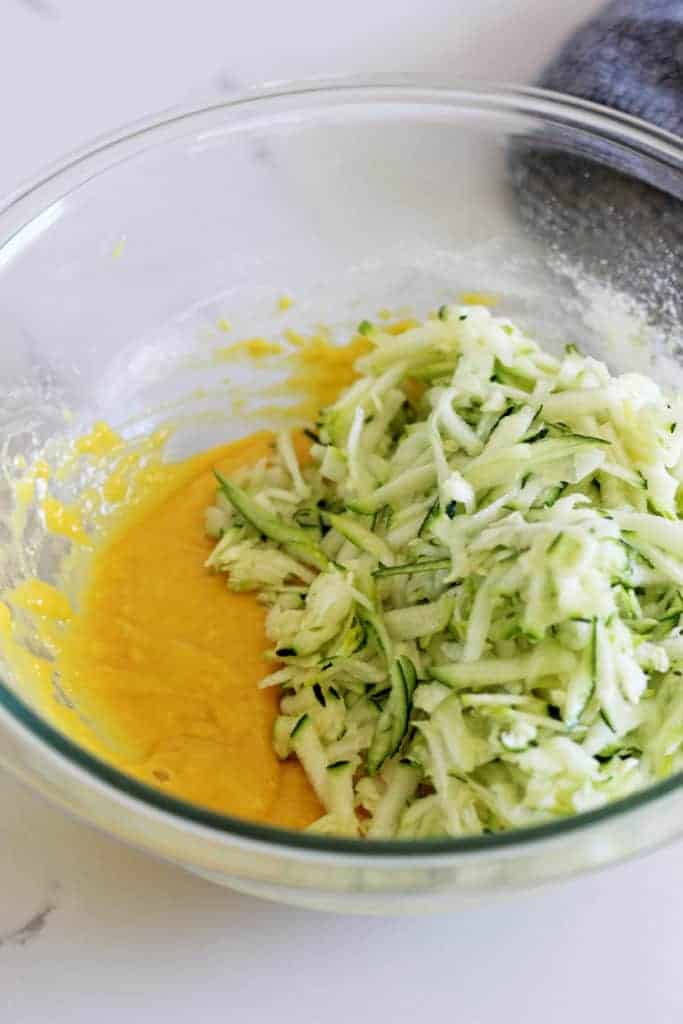 Glass bowl with mixture for zucchini fritters
