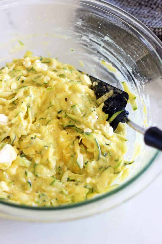 Glass bowl with mixture for zucchini fritters