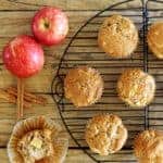 Spiced apple muffins on a wooden background with apples and cinnamon sticks plus text overlay