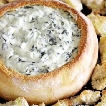 Cob loaf filled with cheesy spinach dip
