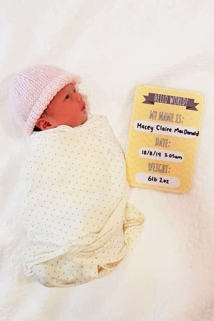 Baby Macey with birth announcement card